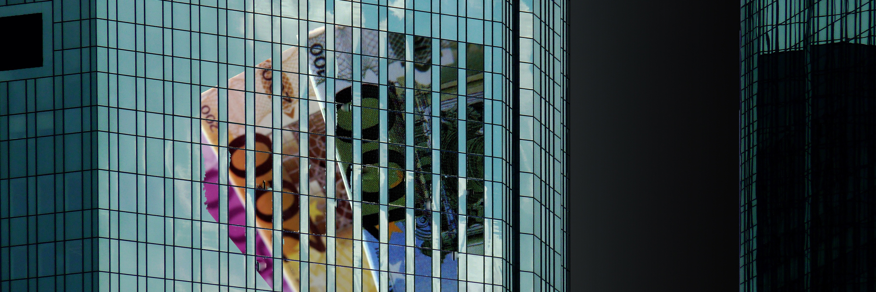 Building with glass front and banknotes reflected in it